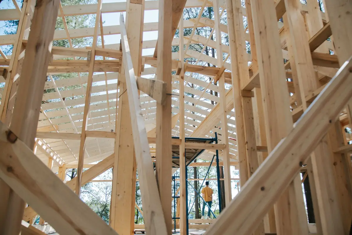 Interior view of new wood wall and roof framing during a home construction project